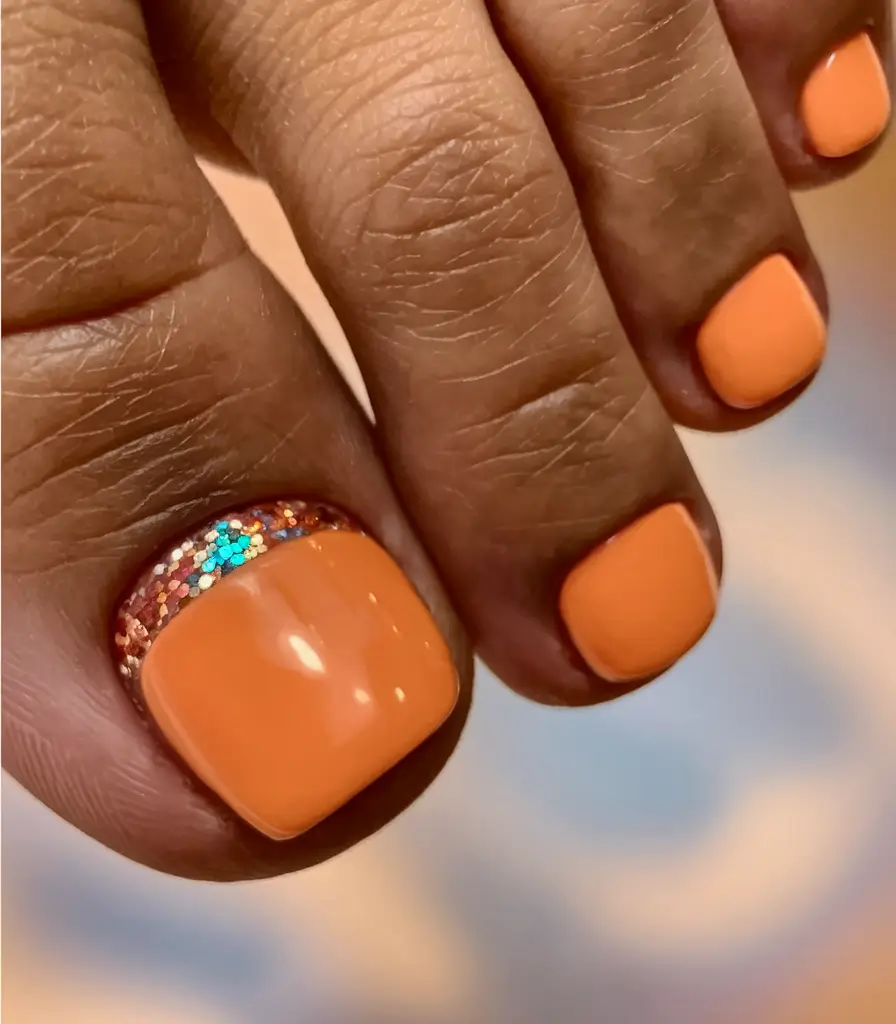august toe nails ideas 2025 Peachy Coral with Glitter Roots
