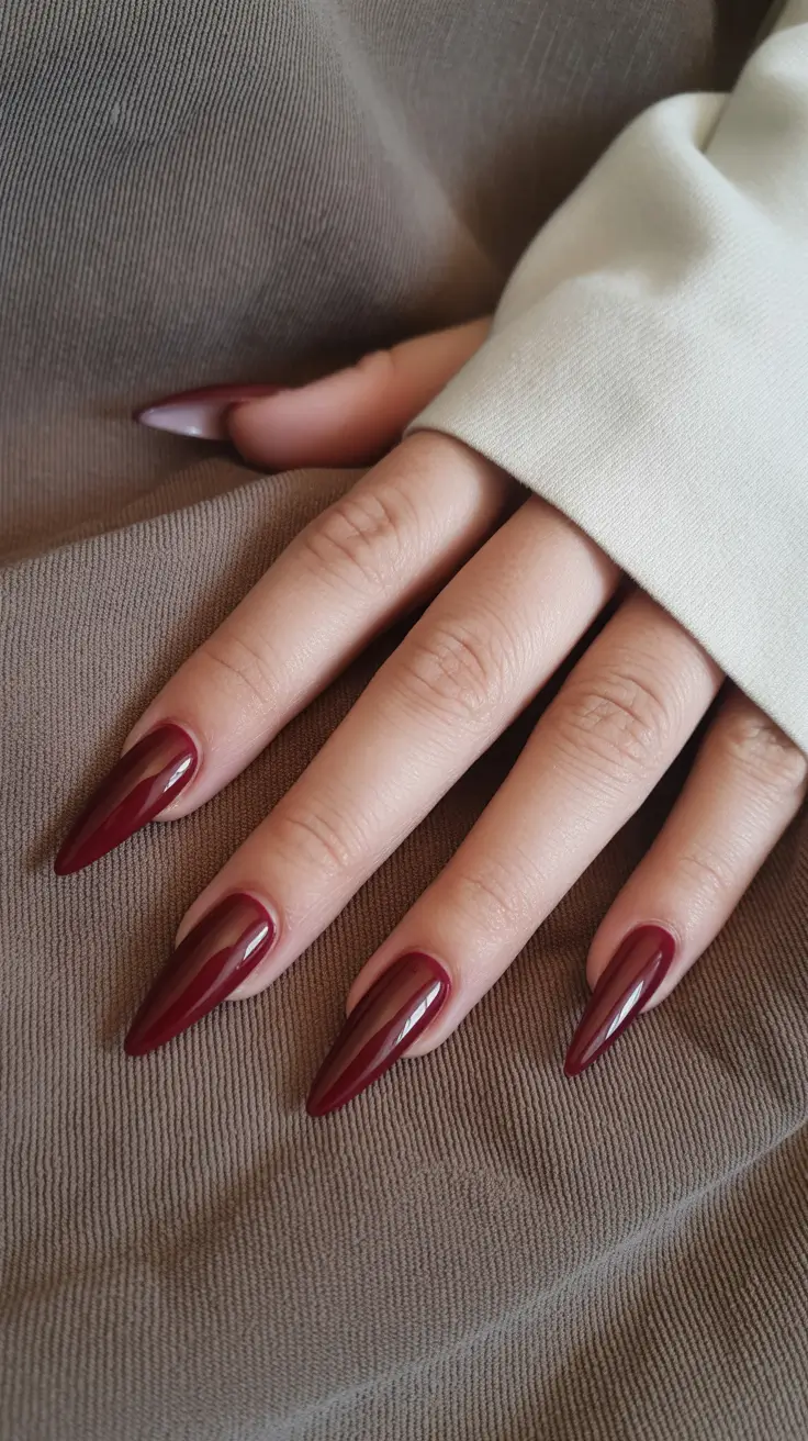 dark burgundy nails 2026 Ruby-Toned Stiletto Silhouette