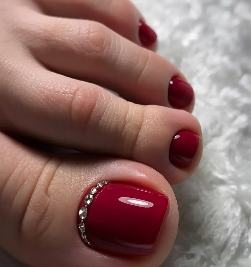toe nail designs 2026 Classic Red Elegance With a Crystal Curve