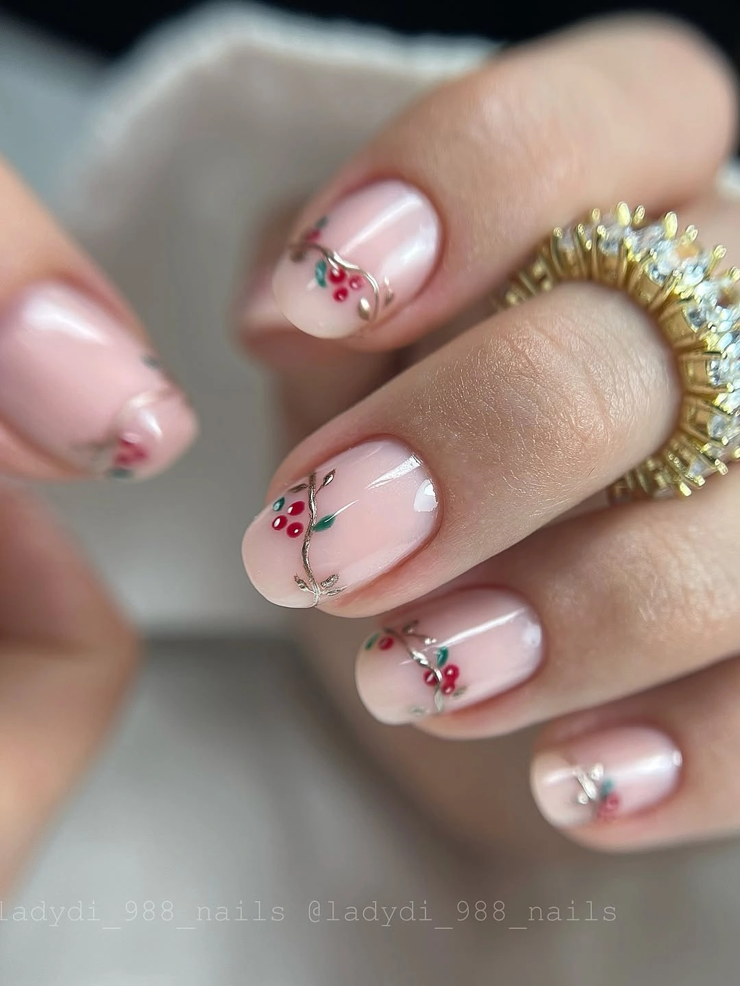 Short milky pink nails with red berries and delicate green stems