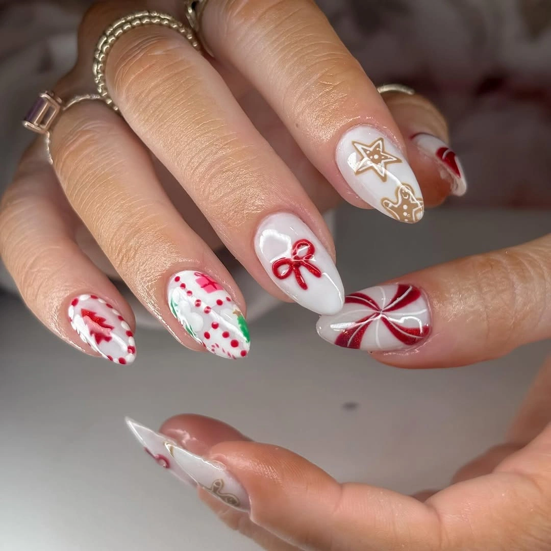 Long white almond nails with red bows, candy stripes and gold stars