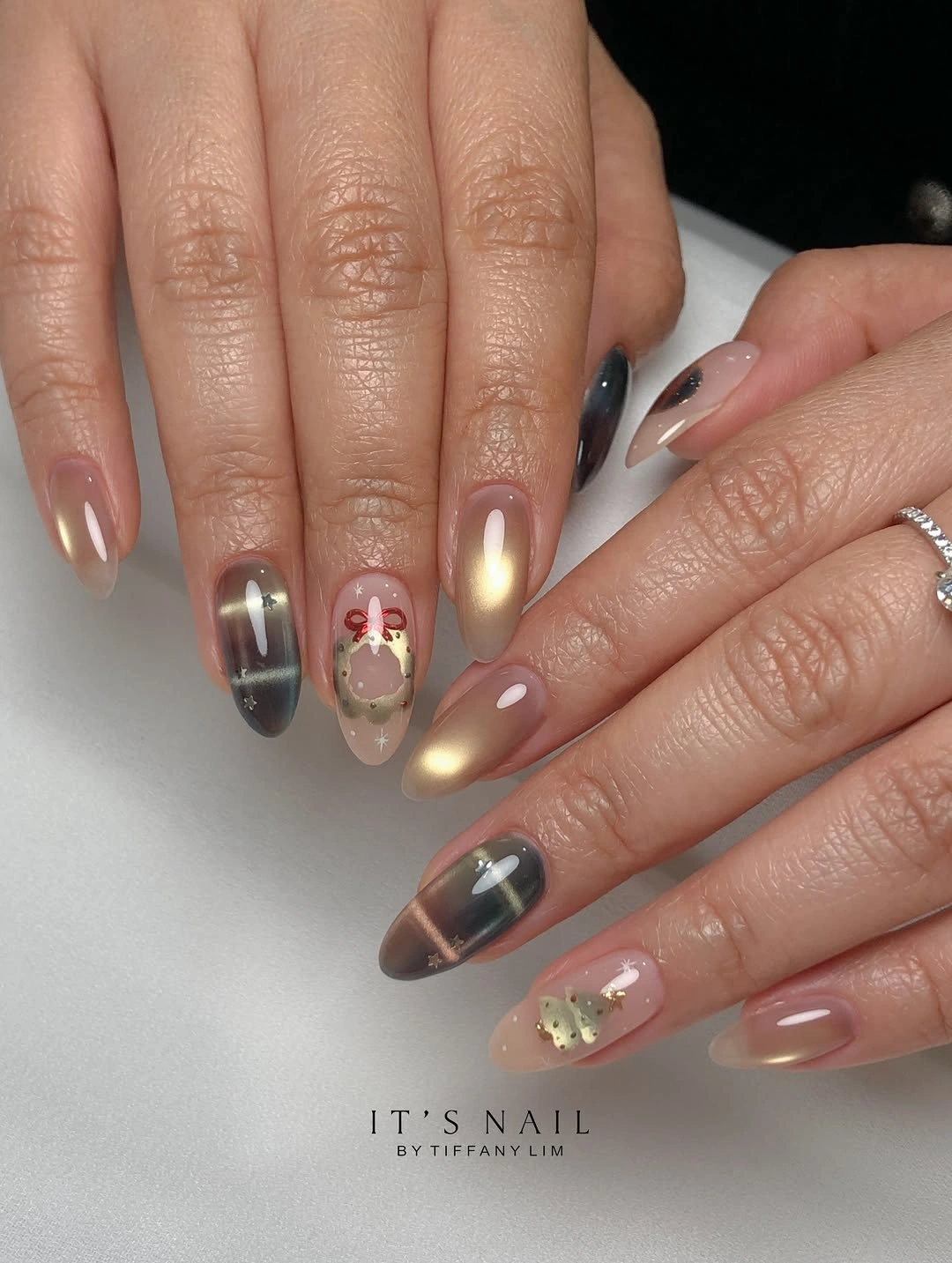 Long almond nails with champagne reflections, smoky plaid and tiny red decorations