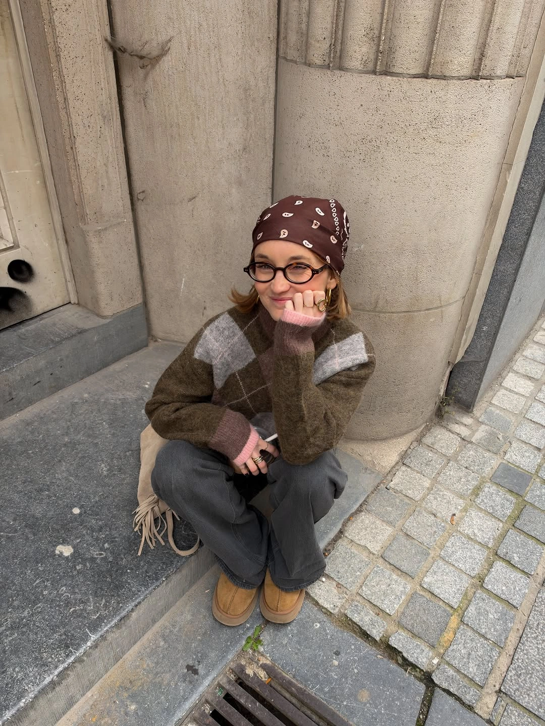 Olive brown argyle sweater with burgundy headscarf and loose charcoal pants