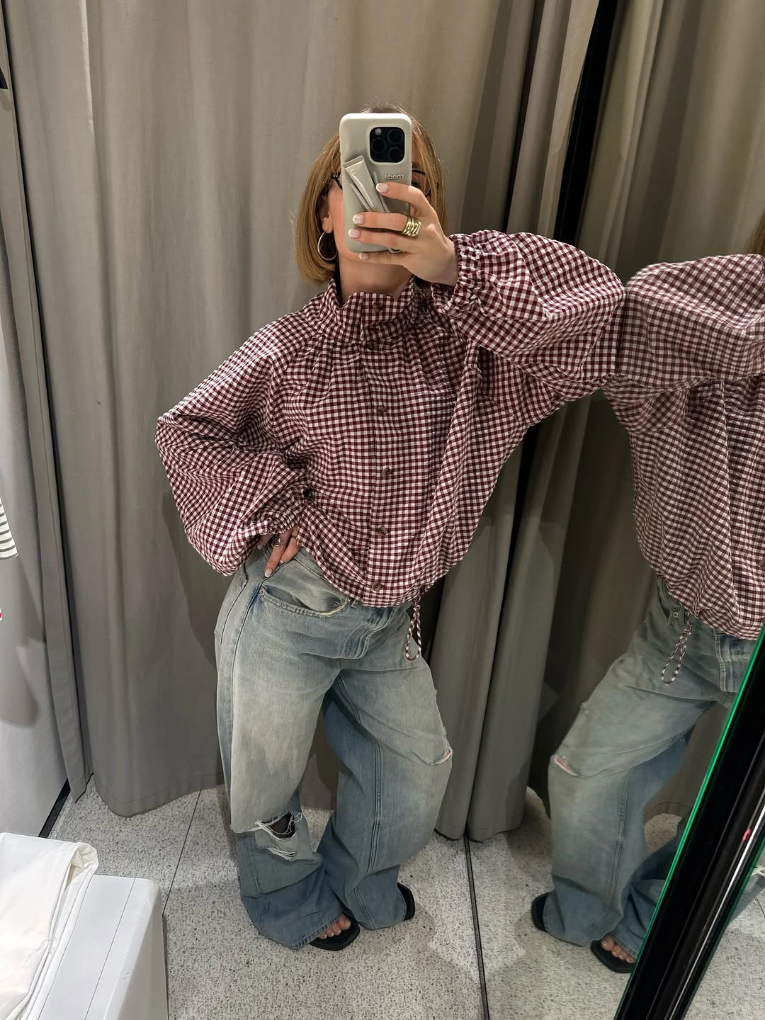 Burgundy gingham blouse with balloon sleeves and distressed light blue jeans